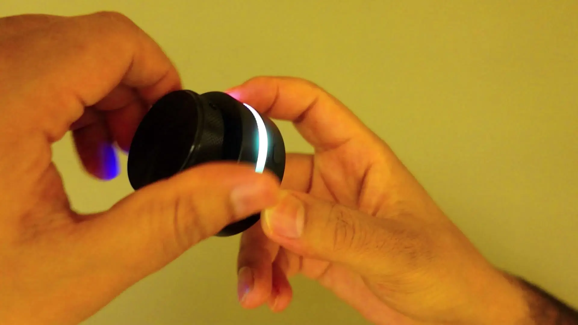 Dual-knob RGB metal scroll controller glowing cyan between the two knurled dials