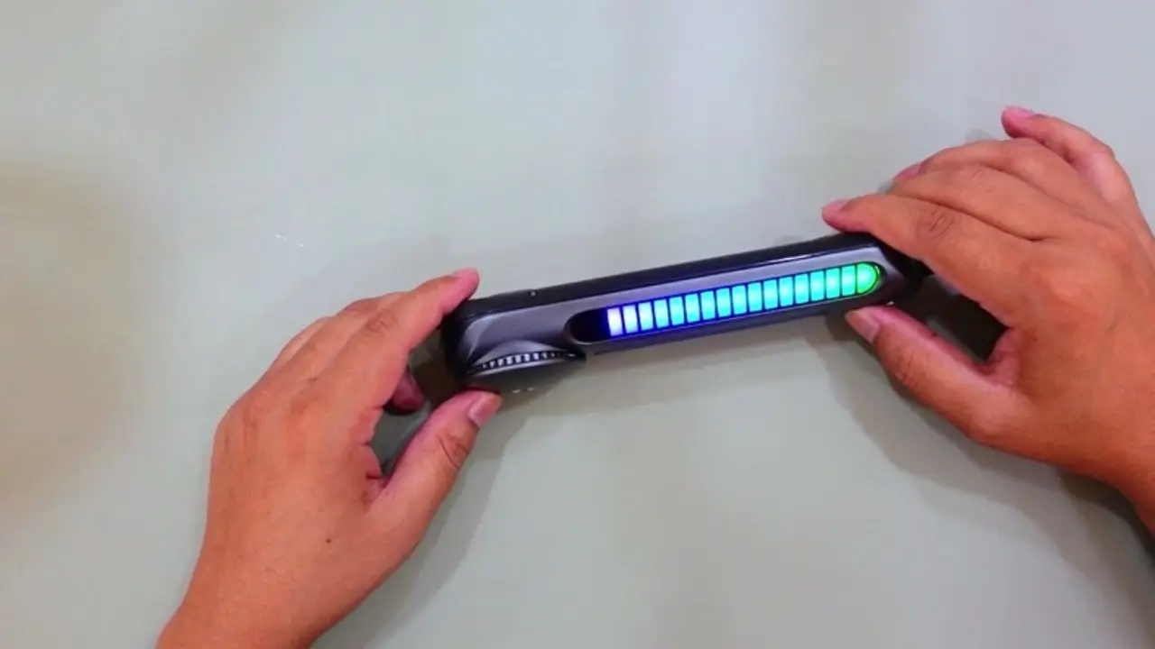 The car bar's RGB strip mid-cycle, showing a blue-to-green LED gradient sweep across the front panel