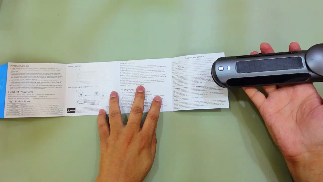 The instruction manual spread open on a desk beside the car bar, showing diagrams of the privacy number plate dial and product parameters