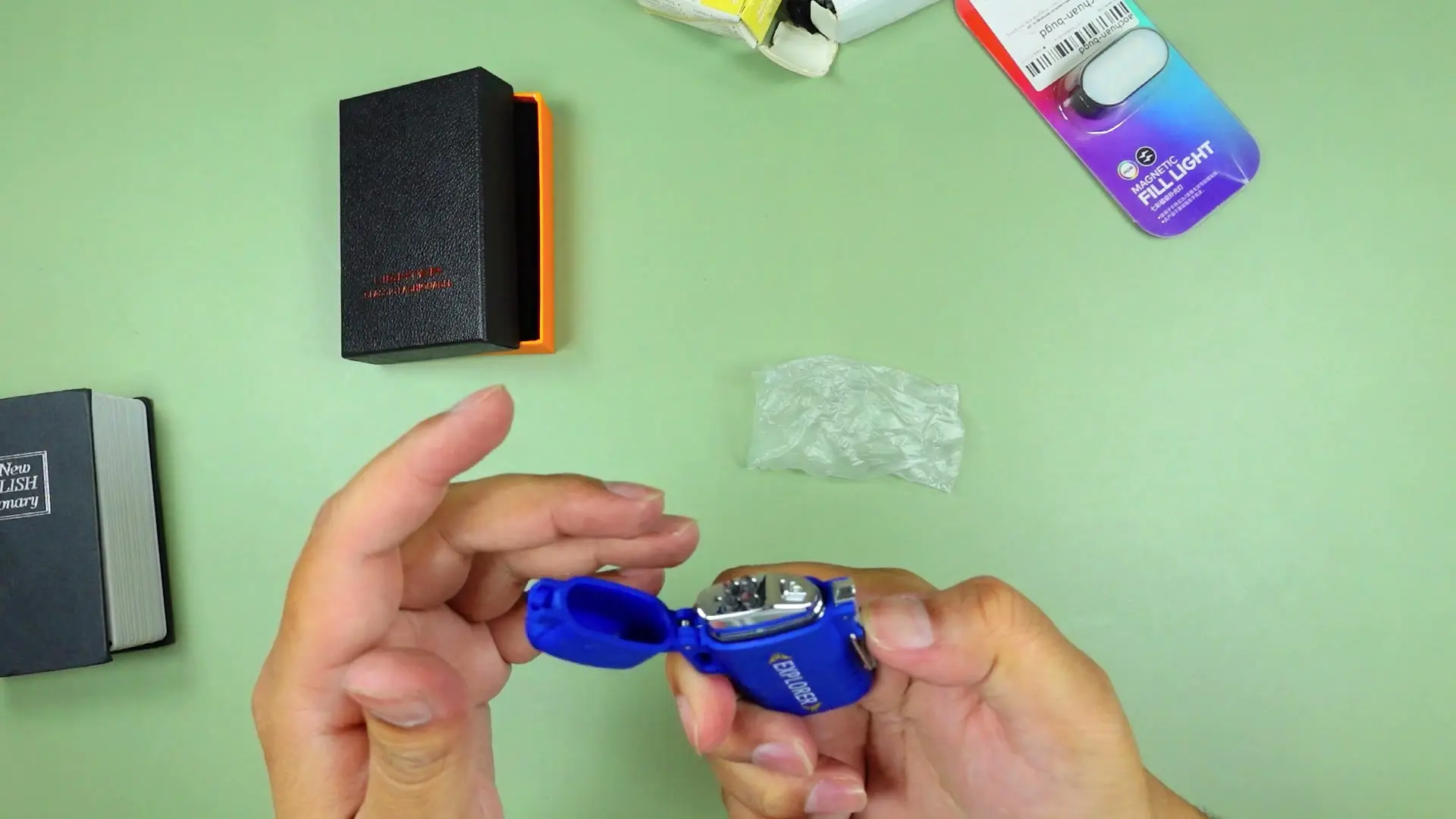 The EXPLORER USB arc lighter opened, showing its metal dual-electrode arc-ignition head