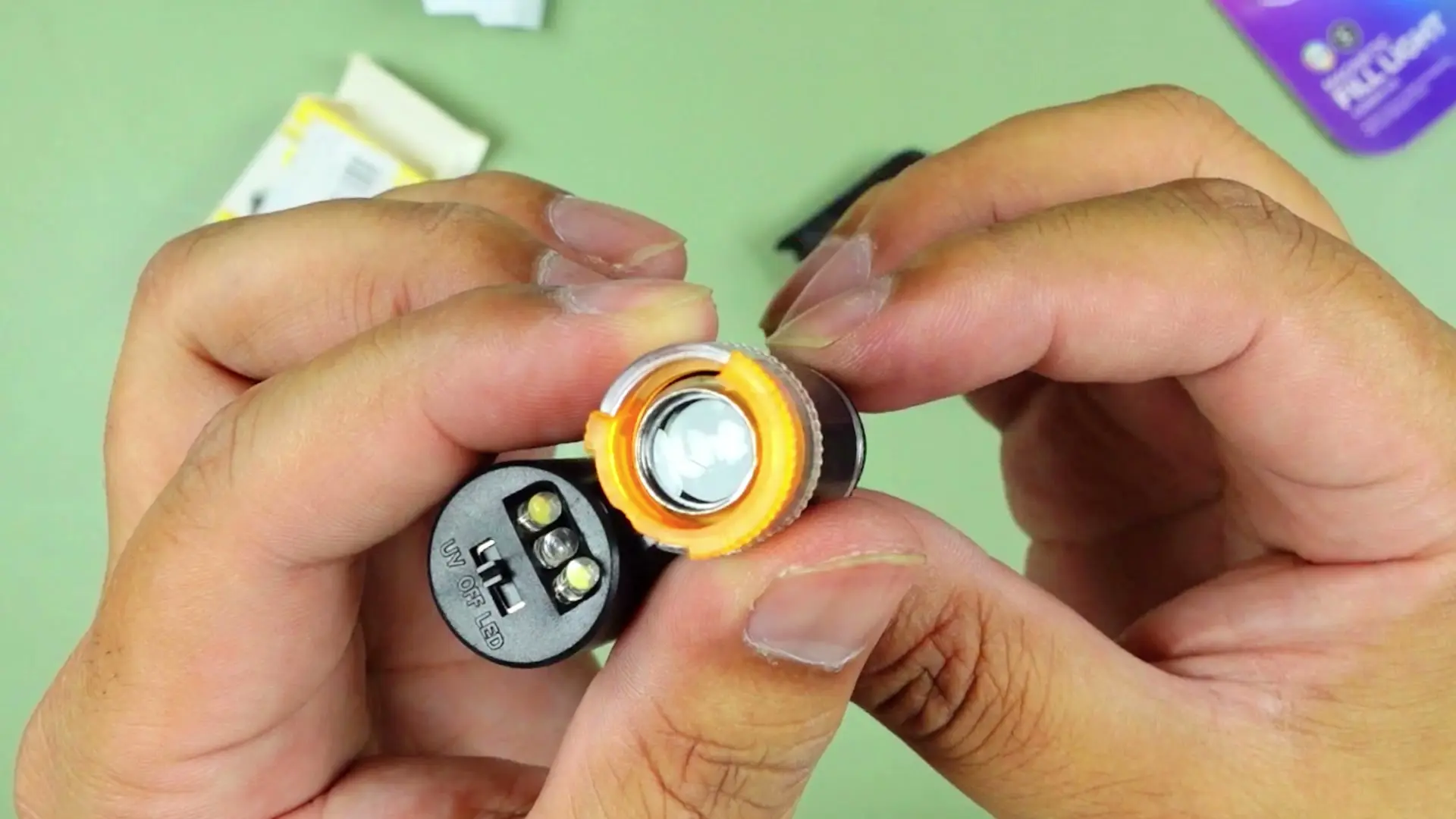 The 60X pocket microscope's UV / OFF / LED switch dial, with the LED setting lit up